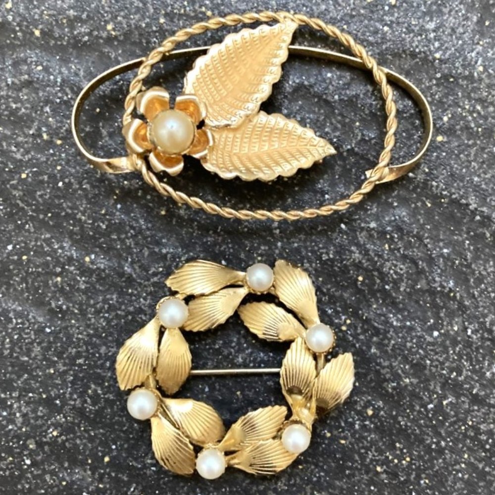 Pair of vintage golden pearl brooches in leafy designs
